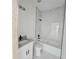 Modern bathroom with white marble tile, dark fixtures, and a combined shower and bathtub at 1236 N Virginia Ave, Lakeland, FL 33805