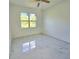 Bright bedroom featuring large window, ceiling fan, and marble-style tile floors at 1236 N Virginia Ave, Lakeland, FL 33805