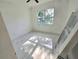 Bright, minimalist bedroom with marble floors, ceiling fan, and view through a large picture window at 1236 N Virginia Ave, Lakeland, FL 33805