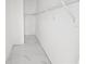 Walk-in closet featuring a hanging rack, white walls and marble-style tile flooring at 1236 N Virginia Ave, Lakeland, FL 33805