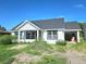 Charming single-story home featuring a modern design with an open garage and unfinished landscaping at 1236 N Virginia Ave, Lakeland, FL 33805
