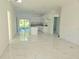 Bright, open-concept kitchen and living area features white cabinets, granite countertops and sliding glass doors at 1236 N Virginia Ave, Lakeland, FL 33805