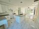 A modern kitchen featuring a granite island, white cabinetry, and a seamless flow into the living area at 1236 N Virginia Ave, Lakeland, FL 33805