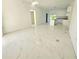 A modern living space and kitchen with marble floors, white cabinets, and access to the outdoors at 1236 N Virginia Ave, Lakeland, FL 33805
