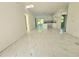 A bright, spacious living room boasts modern finishes, with an adjoining kitchen and view to outdoor space at 1236 N Virginia Ave, Lakeland, FL 33805