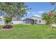 Expansive backyard featuring a screened patio, lush lawn, and privacy fence at 14287 E Weymouth Run, Orlando, FL 32828