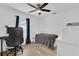 Cozy bedroom featuring wood flooring, wainscoting, a modern desk, and comfortable furnishings at 14287 E Weymouth Run, Orlando, FL 32828