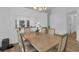 Bright dining room featuring modern lighting, wood floors, and a pass-through to the kitchen at 14287 E Weymouth Run, Orlando, FL 32828
