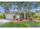 Charming single-story home with a two-car garage, landscaped yard, and inviting curb appeal at 14287 E Weymouth Run, Orlando, FL 32828