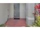 Inviting front porch with decorative brick tile and a modern gray front door at 14287 E Weymouth Run, Orlando, FL 32828
