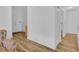 Hallway showing access to other rooms, including a bathroom with modern flooring and lighting at 14287 E Weymouth Run, Orlando, FL 32828