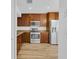 This kitchen features wooden cabinets, stainless steel appliances, and durable laminate floors at 14287 E Weymouth Run, Orlando, FL 32828