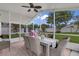 Relaxing screened patio with brick flooring, ceiling fan, and views of the backyard at 14287 E Weymouth Run, Orlando, FL 32828