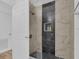 Updated shower with black river rock base, shower niche, and marble wall tile at 14287 E Weymouth Run, Orlando, FL 32828