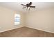 Neutral bedroom with carpeting, fan, and a window bringing in natural light at 1749 Christina Lee Ln, St Cloud, FL 34769