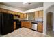 Bright kitchen featuring tile floors, wood cabinets, and stainless-steel dishwasher at 1749 Christina Lee Ln, St Cloud, FL 34769