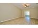 Spacious living room with sliding glass doors, ceiling fan, and light wood flooring at 1749 Christina Lee Ln, St Cloud, FL 34769
