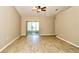 Spacious living room with sliding glass doors, ceiling fan, and light wood flooring at 1749 Christina Lee Ln, St Cloud, FL 34769