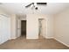 Carpeted bedroom with ceiling fan and ensuite bathroom and closet access at 1749 Christina Lee Ln, St Cloud, FL 34769