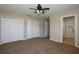 Carpeted bedroom with ceiling fan and access to ensuite bathroom and closet at 1749 Christina Lee Ln, St Cloud, FL 34769