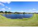 Beautiful community pond with a fountain creating a serene view surrounded by lush green landscaping and blue skies at 1749 Christina Lee Ln, St Cloud, FL 34769