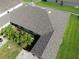 Aerial shot showcasing a well-maintained roof with mature palm trees and landscaping in the front yard at 1749 Christina Lee Ln, St Cloud, FL 34769