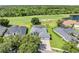 A beautiful aerial view of a well-manicured lawn and lovely home bordering a lush green golf course at 1810 Lee Janzen Dr, Kissimmee, FL 34744