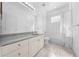 Well-lit bathroom featuring a shower-tub combination and vanity with ample storage at 1810 Lee Janzen Dr, Kissimmee, FL 34744