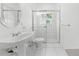 Well-lit bathroom featuring a modern pedestal sink and glass-enclosed shower at 1810 Lee Janzen Dr, Kissimmee, FL 34744