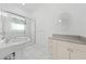 Bright bathroom with a sleek glass shower and modern pedestal sink at 1810 Lee Janzen Dr, Kissimmee, FL 34744