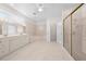 Bright bathroom features a double vanity, walk-in shower, soaking tub and tile floors at 1810 Lee Janzen Dr, Kissimmee, FL 34744