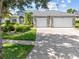 Charming home featuring a well-manicured lawn, stone accents and a three car garage at 1810 Lee Janzen Dr, Kissimmee, FL 34744