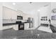 Well-lit kitchen features modern appliances, ample white cabinetry, and sleek black countertops at 1810 Lee Janzen Dr, Kissimmee, FL 34744