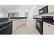 Well-lit kitchen featuring granite countertops, tile flooring, and modern appliances at 1810 Lee Janzen Dr, Kissimmee, FL 34744