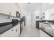 Modern kitchen featuring granite countertops, tile flooring, and stainless steel appliances at 1810 Lee Janzen Dr, Kissimmee, FL 34744