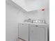 Bright laundry room with Maytag washer and dryer and wire rack shelving at 1810 Lee Janzen Dr, Kissimmee, FL 34744