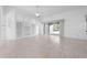 Spacious living room with tile flooring, built-in shelving, and access to the outdoor patio at 1810 Lee Janzen Dr, Kissimmee, FL 34744