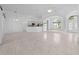 Spacious living room with tile floors, an open kitchen, and a clear view of the front doors at 1810 Lee Janzen Dr, Kissimmee, FL 34744
