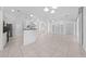 Open layout with tile flooring seamlessly blends the kitchen and living areas at 1810 Lee Janzen Dr, Kissimmee, FL 34744