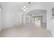 Open-concept living room with tile flooring, arches, and access to outdoor spaces at 1810 Lee Janzen Dr, Kissimmee, FL 34744
