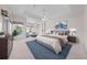 Spacious bedroom with sitting area features a tray ceiling and views of the pool at 1810 Lee Janzen Dr, Kissimmee, FL 34744