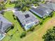 Aerial view of a screened-in pool, solar panels, and green grass backyard in a home at 1810 Lee Janzen Dr, Kissimmee, FL 34744