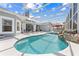 Beautiful screened-in pool with a waterfall feature and gazebo, perfect for relaxing and entertaining at 1810 Lee Janzen Dr, Kissimmee, FL 34744