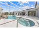 Screened pool and spa with waterfall feature and lounge chairs at 1810 Lee Janzen Dr, Kissimmee, FL 34744