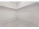 Spacious walk-in closet with tile floor and lots of built-in shelving at 1810 Lee Janzen Dr, Kissimmee, FL 34744