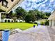 Spacious backyard, lush green lawn, decorative pots, all surrounded by a white vinyl fence at 1921 Japonica Rd, Winter Park, FL 32792