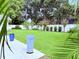 Scenic backyard featuring a lush green lawn, landscaping and a white vinyl fence at 1921 Japonica Rd, Winter Park, FL 32792