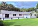 Large backyard featuring a well-maintained lawn, a patio, and plenty of space for outdoor activities at 1921 Japonica Rd, Winter Park, FL 32792