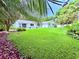 Expansive backyard with lush green grass, mature trees, and privacy fencing, perfect for outdoor living at 1921 Japonica Rd, Winter Park, FL 32792