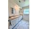 Bright bathroom with marble floors, dual sinks, traditional vanity, and natural light from a window at 1921 Japonica Rd, Winter Park, FL 32792